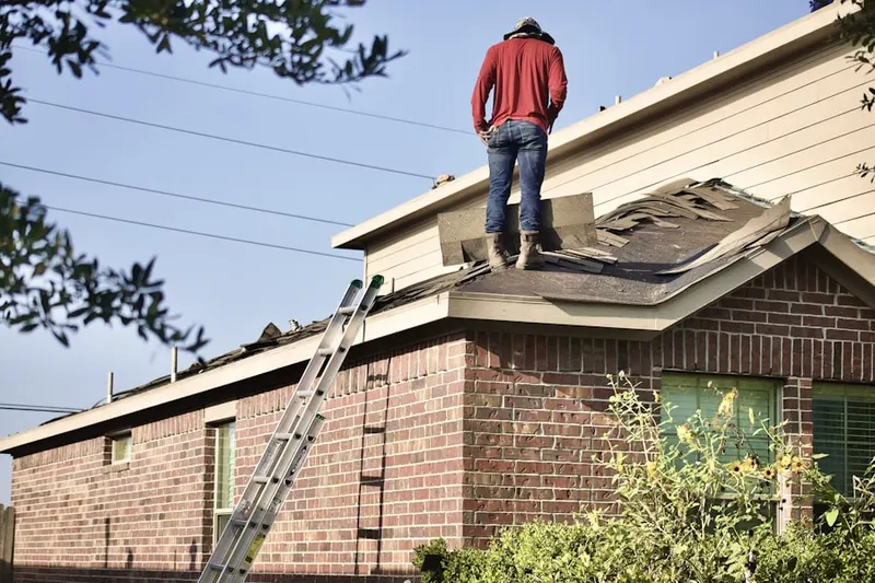 Professional roofer working on a residential roof in Pine Creek